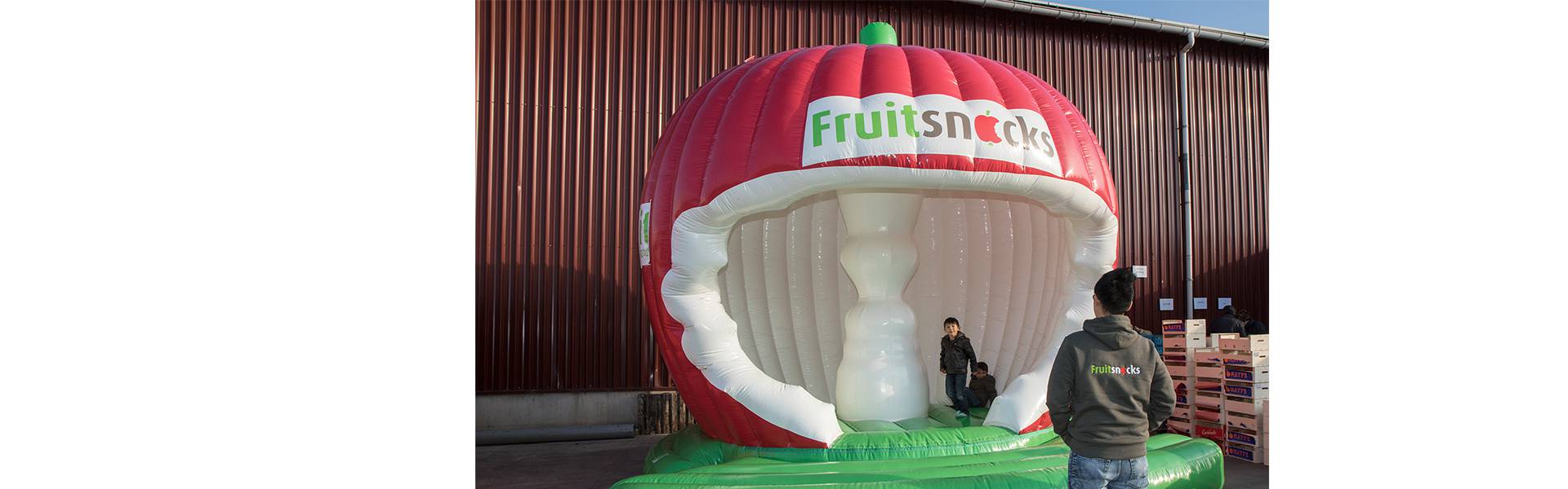 Large inflatable promotional material | X-Treme Creations 3D apple shaped bouncy castle with a nibbled bell house Fruitsnacks X-Treme Creations