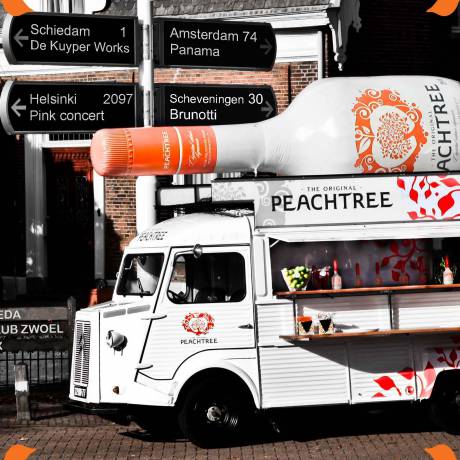 Giant inflatables Draw attention with giant inflatables giant inflatable 4 m bottle Peachtree a product of De Kuyper as eye-catcher on top of a mobile bar oldtimer Citroën HY  X-Treme Creations