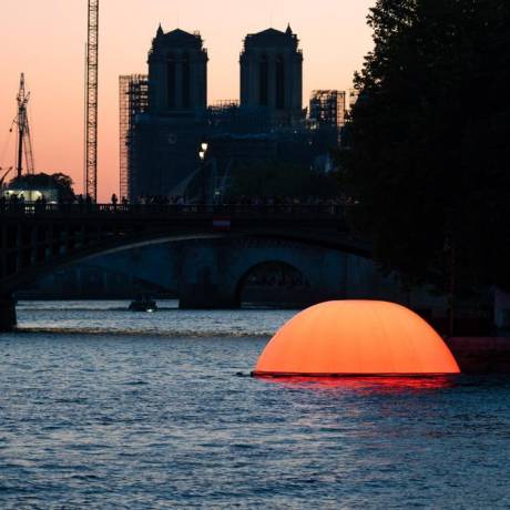 Innovative concepts We design your ideas hybrid inflatable floating sun of 8 m diameter on the river Seine with in the background the Notre Dame cathedral  X-Treme Creations