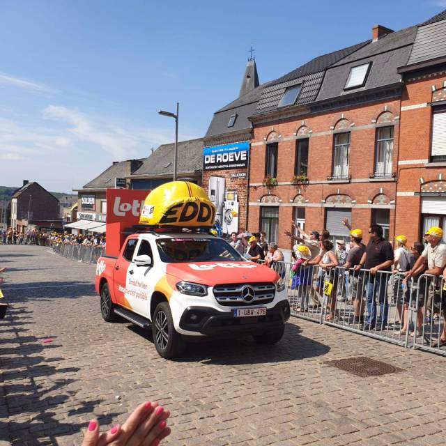 Honoring Eddy Merckx in style during  Giant inflatables inflatable yelllew cap Eddy Merckx  with Lotto branding on the sides in the heat of the action during a classic Belgian cyclist race produced for the Nationale Loterij X-Treme Creations