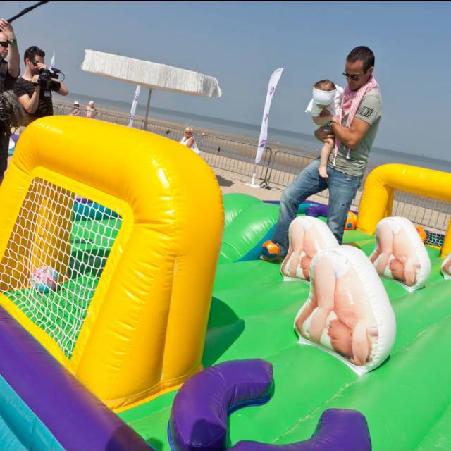 Giant inflatable games Inflatable baby soccer field with famous soccerplayer Gilles Debilde to improve psychomotor skills for very small kids developped for agency 'We make you happy' for Procter and Gamble's Pampers brand at the Belgian coastside X-Treme Creations