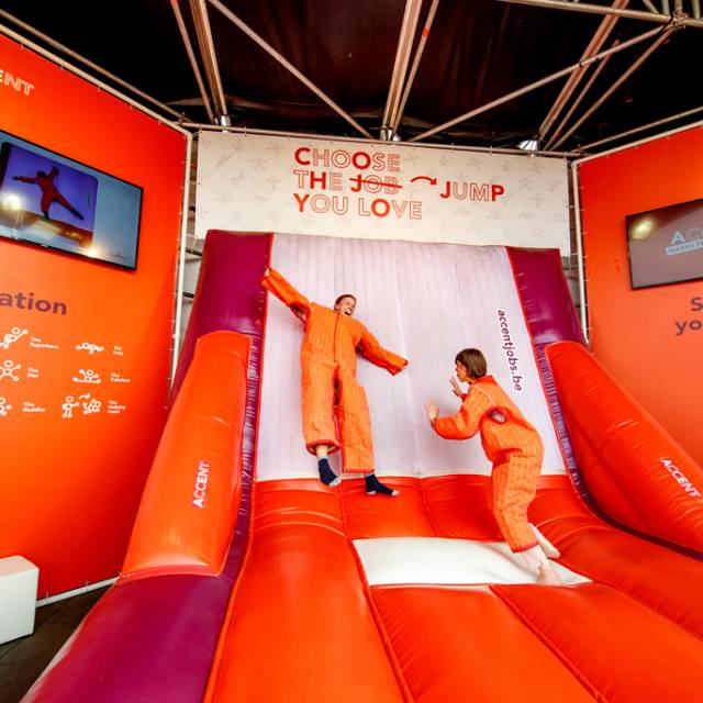 Giant inflatable games inflatable velcro wall with velcro suits as Werchter festival animation for the Human Resources company Accent designed by Plug 'n Play X-Treme Creations