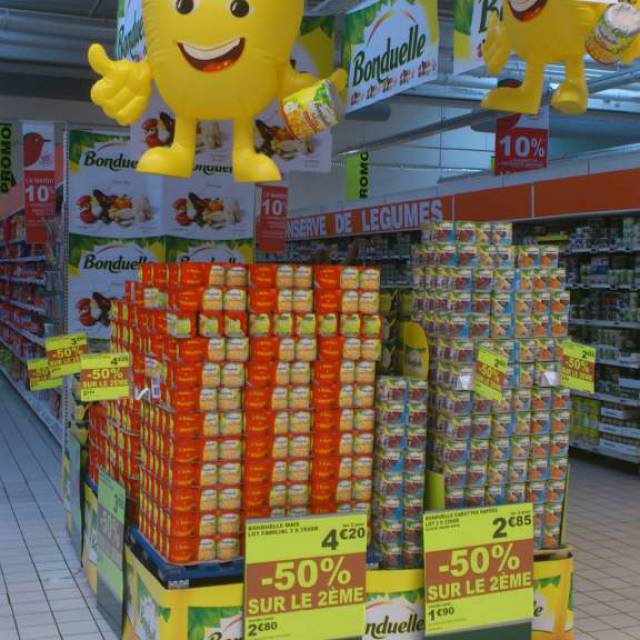Miniature airtight inflatable mascots airtight miniature inflatable corn character mass produced for the brand Bonduelle hanging inside a supermarket in France X-Treme Creations