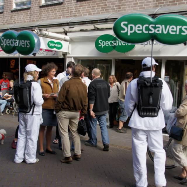 Miniature airtight inflatable logos miniature airtight inflatable logo Specsavers with internal illumination carried by animators in front of the Specsavers shops X-Treme Creations