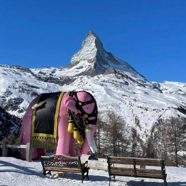 Big inflatable animals inflatable pink elephant nearby a Thai restaurant which Pink Floyd visited in the Swiss Alps with the Matterhorn mountain in the background X-Treme Creations