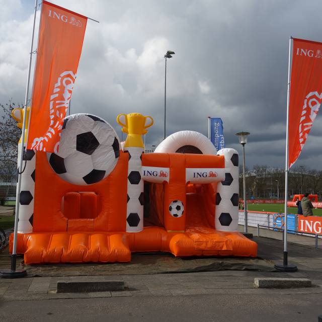 Giant inflatable games Blow-up Obstacle Course for small kids with soccer tailor made decoration for ING bank in the Netherlands X-Treme Creations