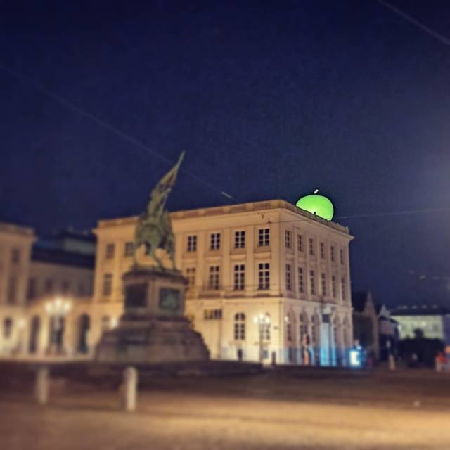 X-Treme Creations inflatable internally illuminated green apple permanently installed on top of the roof of the Brussels Fine Arts Museum