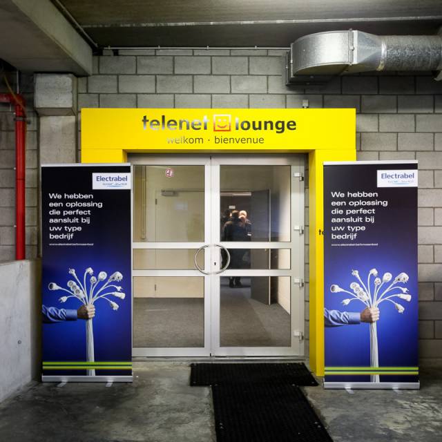 Large format print displays rollups 2 m high for Engie left and right of entrance door of the Telenet Lounge at KV Mechelen X-Treme Creations