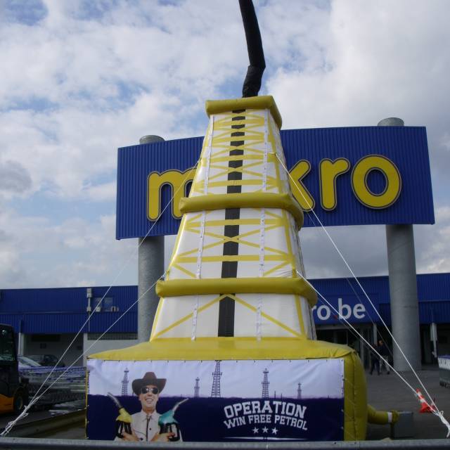 Giant inflatable product enlargements inflatable petrol drill tower with spitting oil nearby the petrol station on the Makro site in Belgium made for the agency BBDO X-Treme Creations