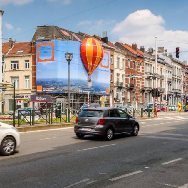 X-Treme Creations Red-orange inflatable balloon that sits in the wall through a combination of 2D and 3D