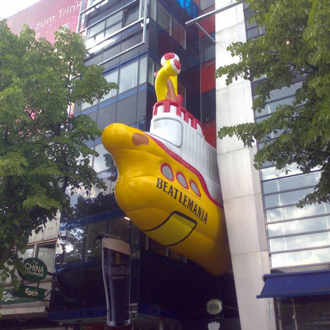 Large inflatable promotional material | X-Treme Creations Inflatable yellow submarine  of 9 meter high as eyecatcher above the entrance of the Beatlesmuseum in the famous Reepersstrasse in Hamburg Art and Design Beatlemania Museum Hamburg Bureau NHP partnership & customer FKP Scorpio X-Treme Creations
