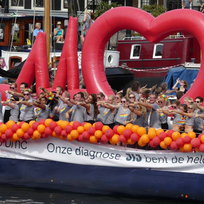 Large inflatable promotional material | X-Treme Creations A gigantic inflatable heart rate line (ECG) on the canal of Amsterdam during the Gay Pride with celebrating people Events  & Festivals  & Corporate branding  & Brand activation  &  Universitair Medisch Centrum Amsterdam  X-Treme Creations